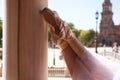 Detail of classical ballet dancer`s legs and feet resting on a white marble column. Classical ballet concept Royalty Free Stock Photo