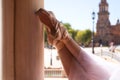 Detail of classical ballet dancer`s legs and feet resting on a white marble column. Classical ballet concept Royalty Free Stock Photo