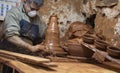 Detail of a clay artisan seen at his warehouse working on a vase