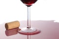 Detail close up on a red wineglass with red wine spilled on the table on white background with copy space for your text