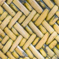 Detail close up view of a uniform golden woven basket using natural branch materials.Pattern of Thai style bamboo handcraft Royalty Free Stock Photo