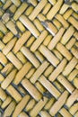 Detail close up view of a uniform golden woven basket using natural branch materials.Pattern of Thai style bamboo handcraft Royalty Free Stock Photo