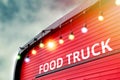 Closed red food truck with light bulb background Royalty Free Stock Photo