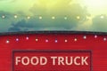 detail of closed red food truck with light bulb in colored sky background Royalty Free Stock Photo