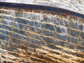Detail and closeup of old and colored boat wooden hull, old painting with cracks and wood texture Royalty Free Stock Photo