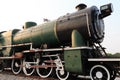 A detail closeup of a steam locomotive releasing steam. Vintage train.