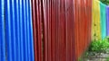 Detail and closeup view of a colorful wooden fence in different colors of the rainbow Royalty Free Stock Photo