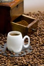 detail of coffee mill with coffee beans and cup of coffee Royalty Free Stock Photo