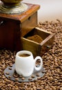 detail of coffee mill with coffee beans and cup of coffee Royalty Free Stock Photo