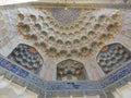 Detail of a colored decorated ceiling to form of stalactites of a mosque to Bukhara in Uzbekistan.