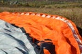 Detail of colorful bright parachute on the ground Royalty Free Stock Photo