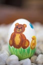Detail of colorful painted Easter eggs with different forms and animals. In that case, a bear Royalty Free Stock Photo