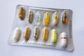 Detail of colorful pills in transparent medicine capsule Royalty Free Stock Photo