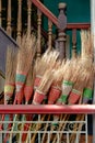 Detail of colorful rustic brooms in wooden stairway