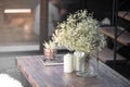 Detail composition of Dried Gypso flower in glass vase setting on vintage brown wood coffee table/scandinavian interior design