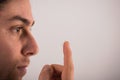 Detail of a contact lens on a man\'s finger which is putting on lens to his eye. Royalty Free Stock Photo