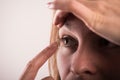 Detail of a contact lens on a woman\'s finger which is putting on lens to his eye. Royalty Free Stock Photo