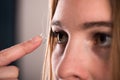 Detail of a contact lens on a woman's finger which is putting on lens to his eye. Royalty Free Stock Photo