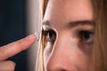 Detail of a contact lens on a woman's finger which is putting on lens to his eye. Royalty Free Stock Photo