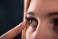 Detail of a contact lens on a woman's finger which is putting on lens to his eye. Royalty Free Stock Photo