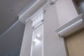 Detail of corner ceiling with intricate crown molding on column with spot light Royalty Free Stock Photo