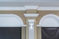 Detail of corner ceiling with intricate crown molding on column with spot light Royalty Free Stock Photo