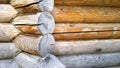 Detail of corner of old wooden house made of beams. Exterior wall. Natural wood material background. Construction industry. Nature Royalty Free Stock Photo