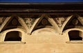 Detail of the cornice, frescoed and two small windows, of a historic and important building in Padua.