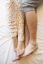 Detail Of Couple's Legs Relaxing In Bed Royalty Free Stock Photo