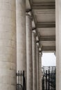 Detail of a court house. Alley with greek columns architecture