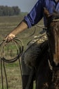 Detail of a cowboy with the lasso in his hand.