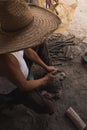 Detail of the craftsman`s hands carving the stone to make molcajetes