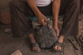 Detail of the craftsman`s hands carving the stone to make molcajetes, traditional Mexican crafts Royalty Free Stock Photo