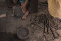 Detail of the craftsman`s hands carving the stone to make molcajetes