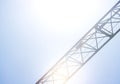 Detail of a crane on bright blue sky used for construction, logistics and industry Royalty Free Stock Photo