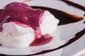 Detail of creamy dessert with berry sauce and chocolate topping