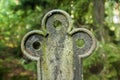 Detail of cross at old semetery in Finland with grave crosses and stones Royalty Free Stock Photo