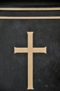 Detail of cross on tombstone in cemetery. Engraving with christian religious symbol in close up Royalty Free Stock Photo