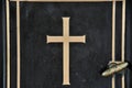 Detail of cross on tombstone in cemetery. Engraving with christian religious symbol in close up Royalty Free Stock Photo