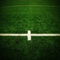 Detail of crossed white lines on outdoor football playground. Detail of lines in a soccer field. Plastic grass and finely ground Royalty Free Stock Photo