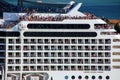 Detail of a crouded cruise ship moving through San Marco canal in Venice, Italy