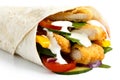 Detail of crumbed fried chicken and salad tortilla wrap with white sauce on white background.