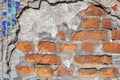 Detail of a crumbling abstract ceramic building decorated with mosaics. Abstract mosaic stones and red bricks