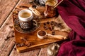 Detail of a cup of coffee and coffee beans on wood background Royalty Free Stock Photo