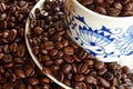 Detail of cup of coffee and pile of coffee beans Royalty Free Stock Photo