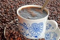Detail of cup of coffee and pile of coffee beans Royalty Free Stock Photo