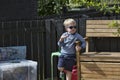 Cute little blonde boy is eating a choc-ice