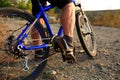 Detail of cyclist man feet riding mountain bike on outdoor