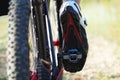 Detail of cyclist man feet riding mountain bike on outdoor. Trail on country road. Only leg are visible Royalty Free Stock Photo