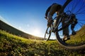 Detail of cyclist man feet riding mountain bike on outdoor trail in sunny meadow Royalty Free Stock Photo